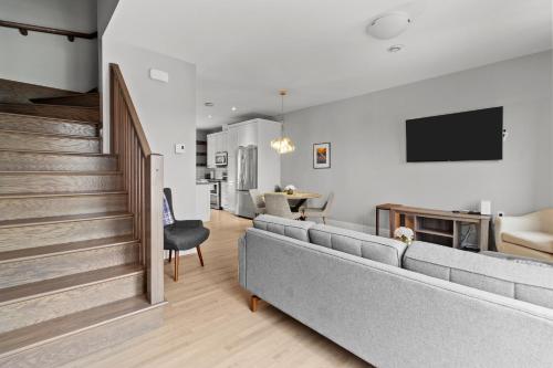a living room with a couch and a tv at Pennywell Prestige 3BR 25BA Garage in St. John's