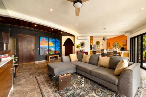 a living room with a couch and a kitchen at Casa Carmen Zona Romantica, 2BD, 3 bath condo in Puerto Vallarta