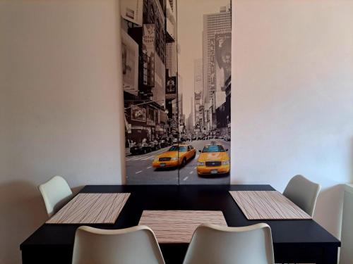 a dining room with a table and two yellow taxis at Lugano Centro Terrazza by Quokka 360 - In Lugano Center with parking in Lugano