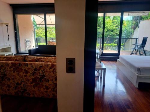 an open door to a living room with a couch at Lugano Centro Terrazza by Quokka 360 - In Lugano Center with parking in Lugano