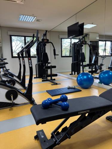 a gym with weights and exercise equipment on a wooden floor at Blue Tree Towers Valinhos in Valinhos