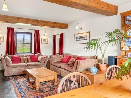 a living room with two couches and a table at Worthy House in Saint Florence