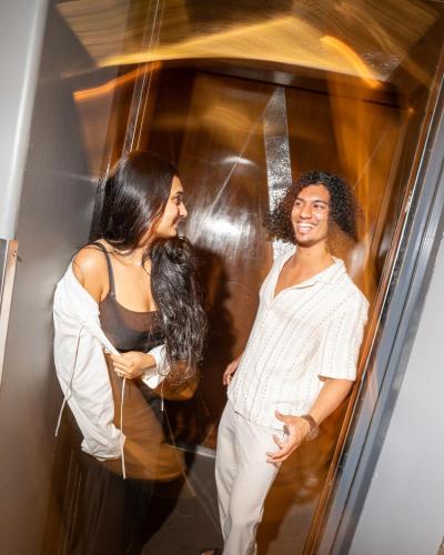 a man and a woman standing in front of an elevator at W Goa in Vagator