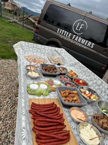 a table with many different types of food on it at Maringotka Květuška ubytování na farmě in Pulečný