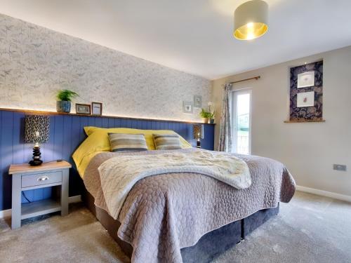 Ένα ή περισσότερα κρεβάτια σε δωμάτιο στο Woodhouse Lodge