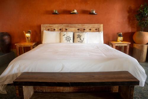 a bedroom with a large bed with a wooden headboard at El Sitio de Playa Venao in Playa Venao
