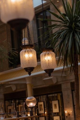 three chandeliers hanging from the ceiling of a building at NoMad London in London