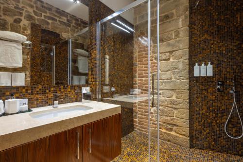 a bathroom with a sink and a glass shower at Donati Luxury Tower Suites in Florence