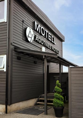 a building with a sign that reads motel accessories hotel at Ågotnes Motell in Ågotnes