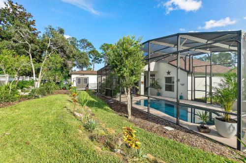 a house with a swimming pool in a yard at The Palms at Eastwood in Palm Coast