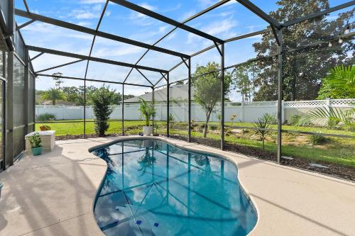 a swimming pool in a glass house at The Palms at Eastwood in Palm Coast