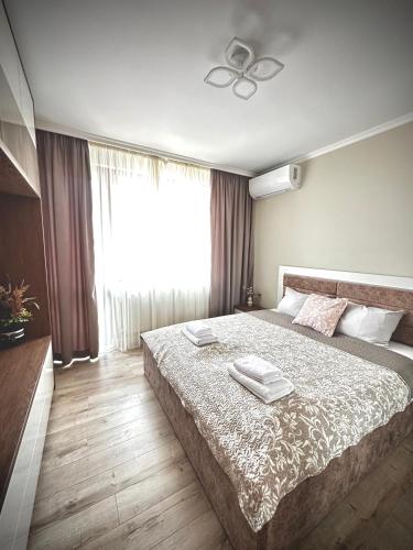 a bedroom with a large bed and a window at View in Petrich