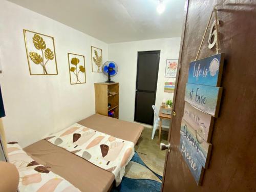 a small room with a bed and a door at WIldFlower in General Luna