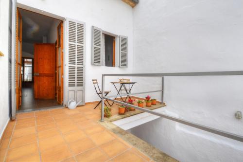 a hallway of a house with a table and some plants at Amilcar House by Slow Villas in Palma de Mallorca