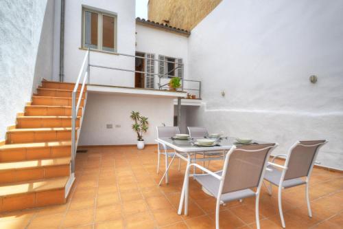 a dining room with a table and chairs and stairs at Amilcar House by Slow Villas in Palma de Mallorca