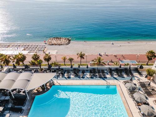 an aerial view of a resort with a beach at Radisson Blu Hotel Nice in Nice