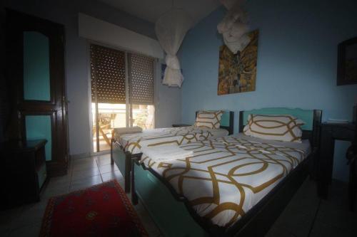 a bedroom with a large bed in a room at keur malaka in Dakar