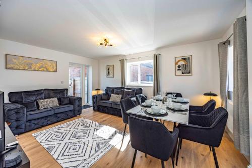 a living room with a table and a couch at Gorgeous Barn with Hot Tub and Games Room in Bunny