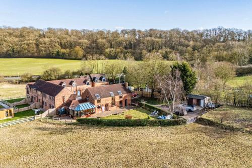 an aerial view of a large house with a yard at Gorgeous Barn with Hot Tub and Games Room in Bunny