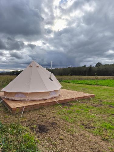 a white tent on a wooden platform in a field at Mardi talu Glamping 