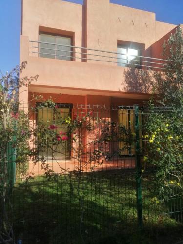 a house with a fence in front of it at Waky Marrakech Villa in El Rhechat