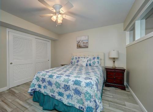 a bedroom with a bed and a ceiling fan at Island House BeachFront Condo Hotel in Corpus Christi