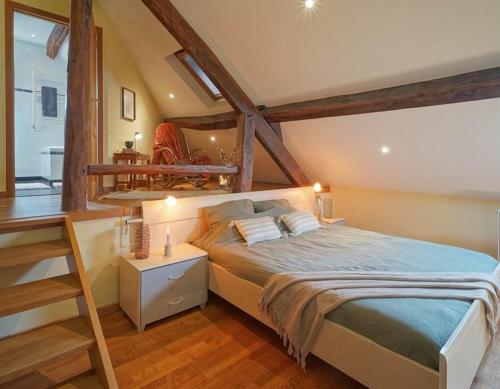 a bedroom with a large bed in a room at La Forge - Chambres d'hôtes en Ardenne in Wellin