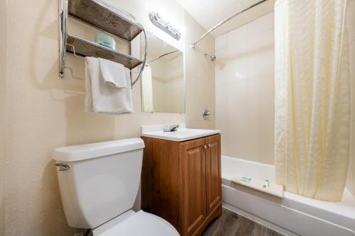 a bathroom with a toilet and a sink and a shower at Banfield Studios By OYO Portland OR in Portland