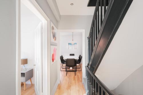 a dining room with a table and chairs at Worthing town house in Worthing
