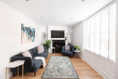 a living room with a couch and two chairs at Worthing town house in Worthing