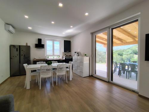 a kitchen and dining room with a table and chairs at La Casetta di Frank - Country House in Chieti