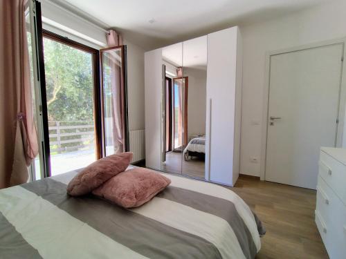 a bedroom with a large bed with a large window at La Casetta di Frank - Country House in Chieti