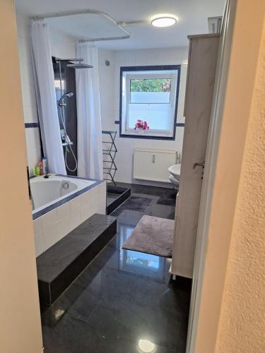 a bathroom with a tub and a sink at Kleeblatt in Chemnitz