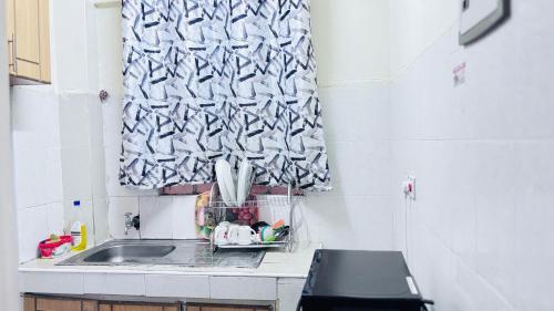 a kitchen counter with a sink and a window at Cosy one bedroom at TRM Drive in Nairobi