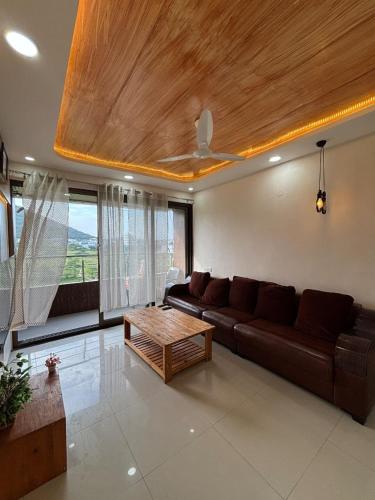a living room with a couch and a coffee table at Pandavleni Service Apartment in Wādhiware