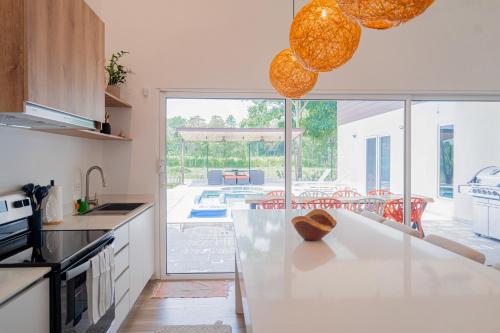 a kitchen with a counter with a view of a patio at Villa Blanca in Esterillos Este