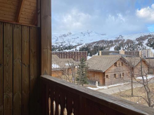 a view of a snowy mountain from a balcony at Residence Le Hameau du Puy by Actisource in Le Dévoluy