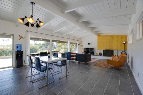 a dining room and living room with a table and chairs at Borrego Springs Retreat with Pool and Mtn Views in Borrego Springs