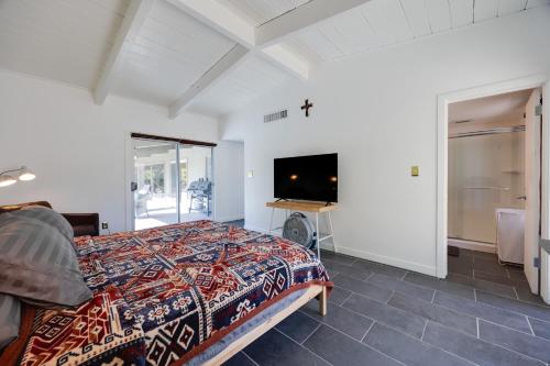 a bedroom with a bed and a flat screen tv at Borrego Springs Retreat with Pool and Mtn Views in Borrego Springs