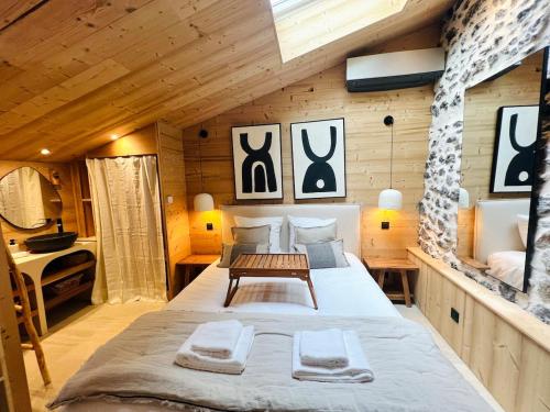 a large bed in a room with wooden walls at Lovely - Duplex by PRIM0 C0NCIERGERIE in Chamalières