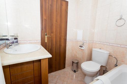 a bathroom with a toilet and a sink at Kaliakria Resort in Topola