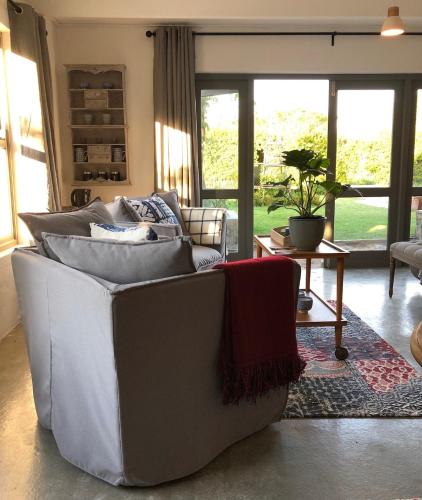 a living room with a couch and a table at The Stanford Getaway Entire House - Pet Friendly in Stanford