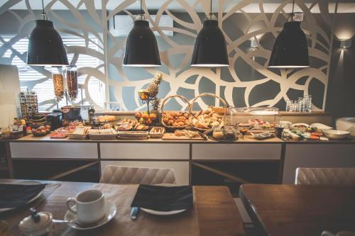 a buffet of food on a table in a restaurant at Hôtel Karène in Saint-Paul-lès-Romans