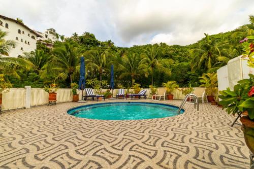 a swimming pool with a patterned floor and a resort at Casa Carmen Zona Romantica, 2BD, 3 bath condo in Puerto Vallarta