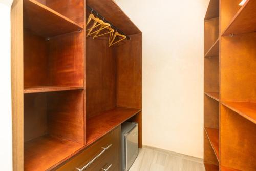 a walk in closet with wooden shelves at Villa Stevana in Oulad Mazoug