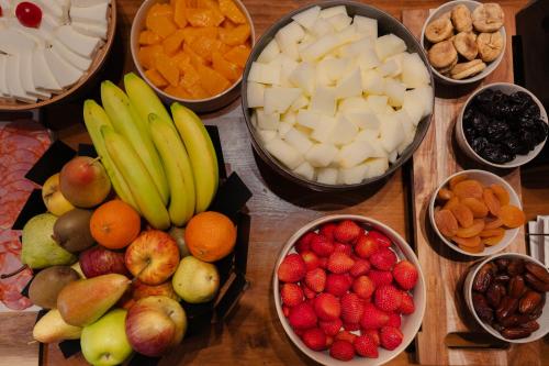 a group of bowls of fruit and nuts on a table at Hotel Dom Carlos Park in Lisbon