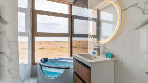 a bathroom with a sink and a mirror and a window at Life resort Marrakech 