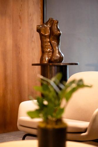 a bronze sculpture sitting on a table next to a plant at Hotel Dom Carlos Park in Lisbon