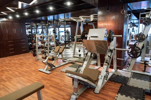 a gym with a lot of treadmills and ellipticals at Central Inn in Dhaka