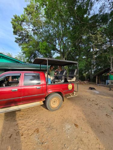 a red truck driving down a dirt road at Veenora Wild - Guest House in Anuradhapura